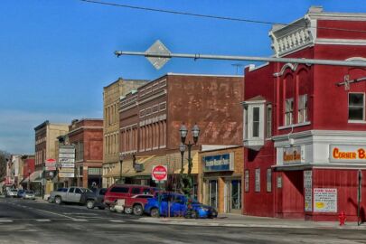 A street scene with cars parked on the side of the road.