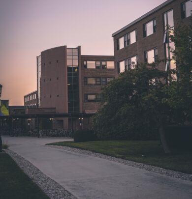 A building with many windows and trees in the background