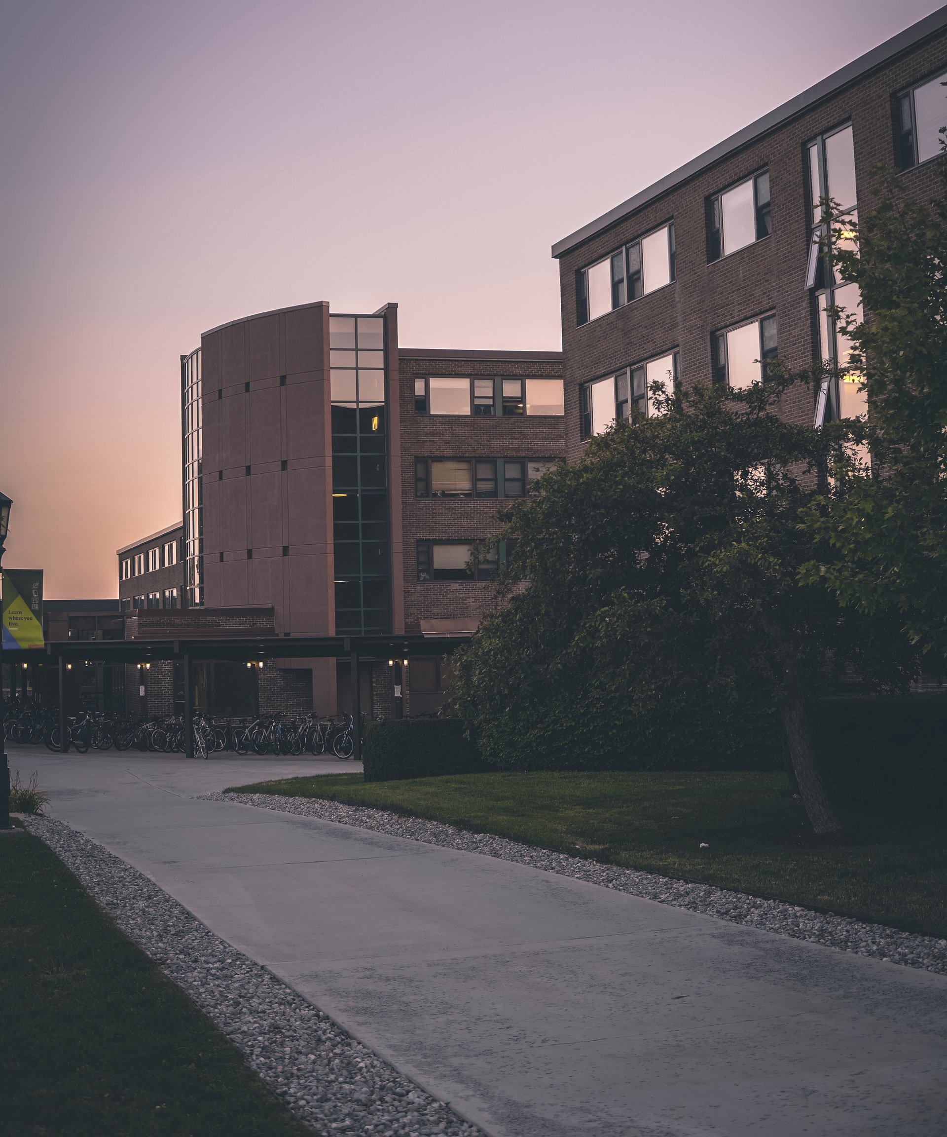 A building with many windows and trees in the background